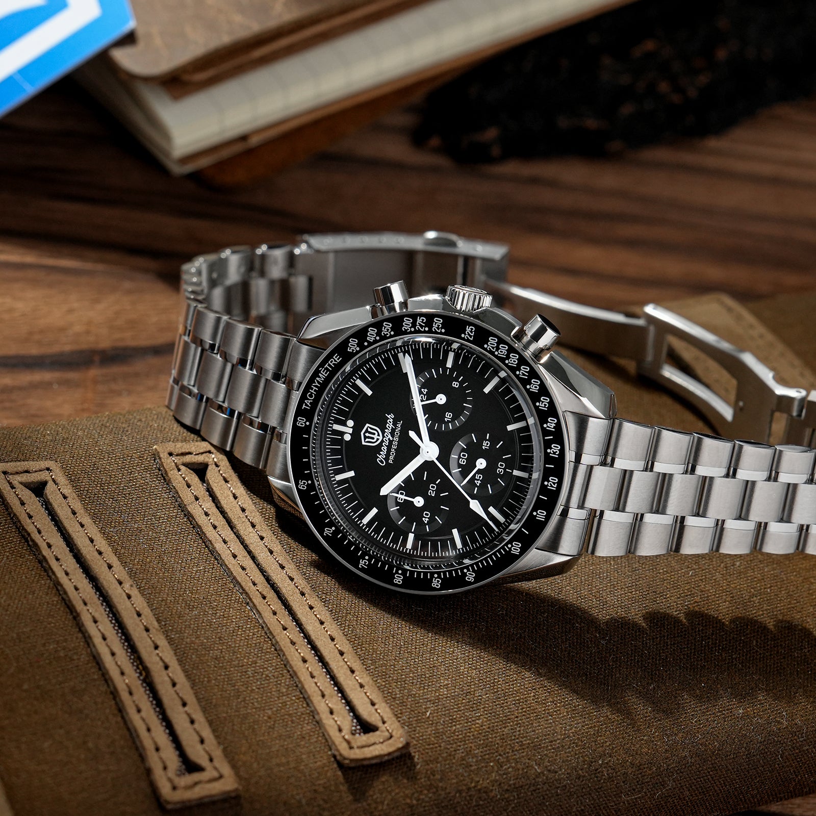 Watchdives WD1860 with black dial, three subdials and steel bracelet on a brown watch pouch
