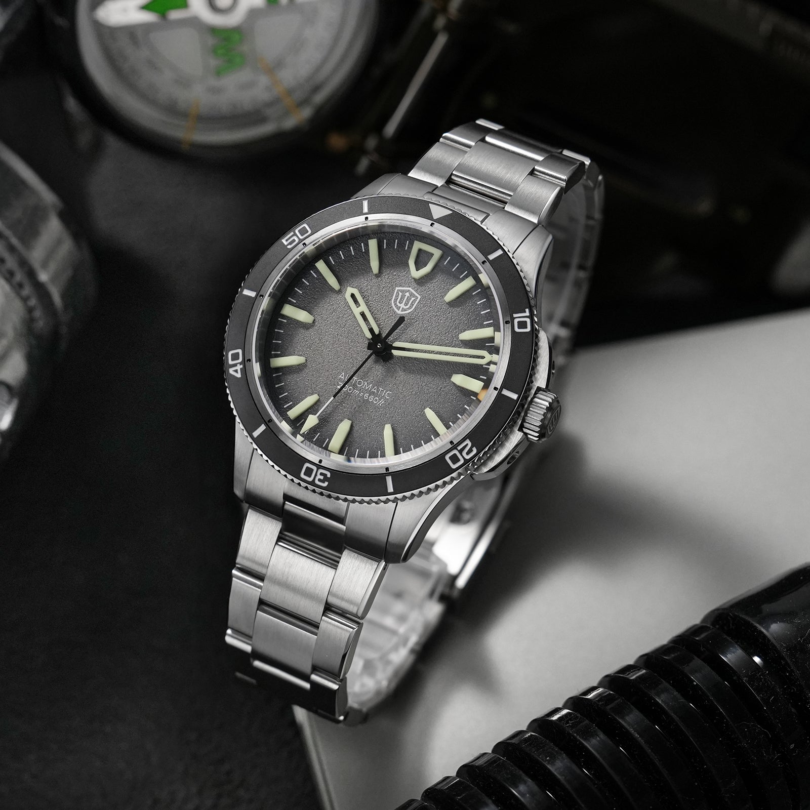 Watchdives Premier WD0019 with a textured dark-grey dial, raised hour markers and brushed three-link steel bracelet